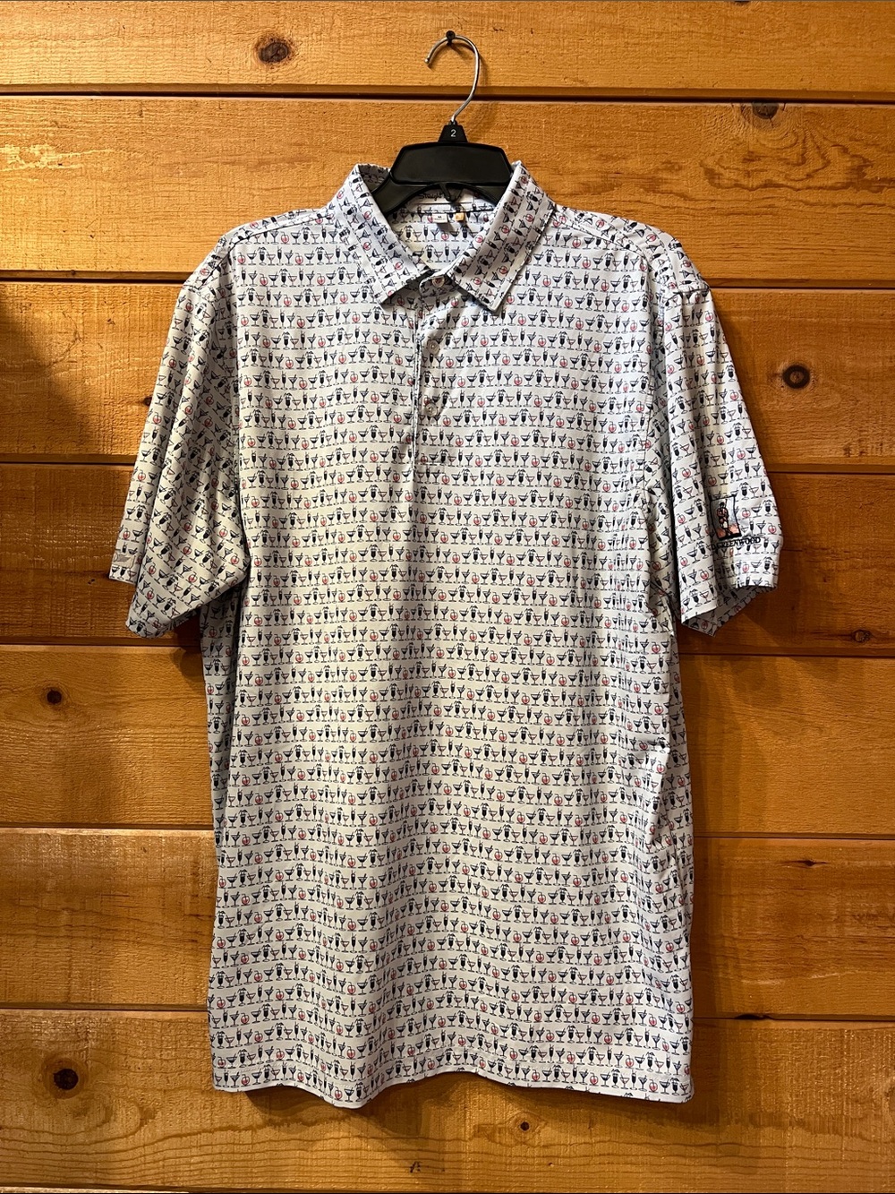 Straight Down men's white polo shirt featuring an all-over martini glass print